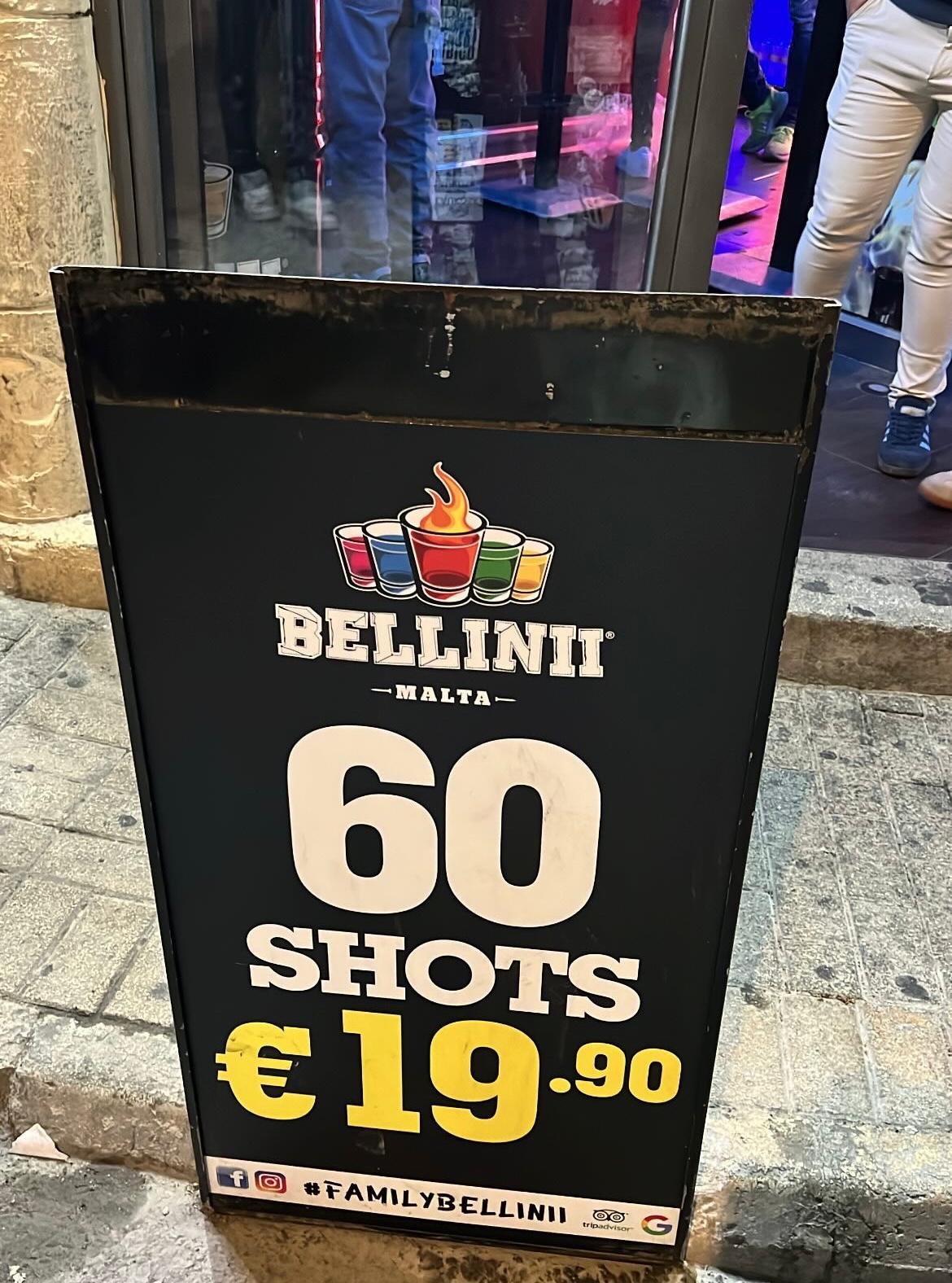 Poster in front of Bellini Bar in Paceville showing attractive shot prices during an ideal day in Malta